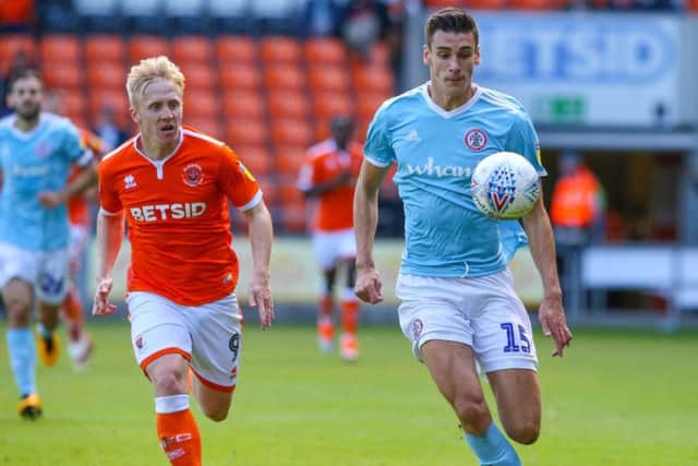 Accrington Stanley's Ross Sykes vies for possession with Blackpool's Mark Cullen