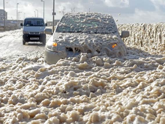 A car covered by sea foam on Cleveleys Prom in 2017