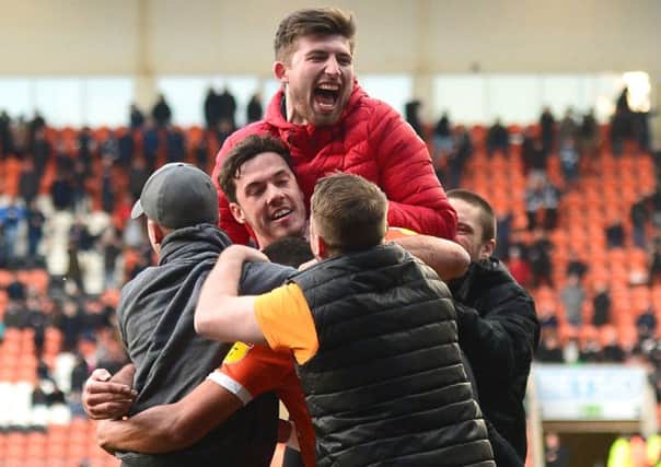 Blackpool supporters mob Ben Heneghan after their late equaliser against Southend United