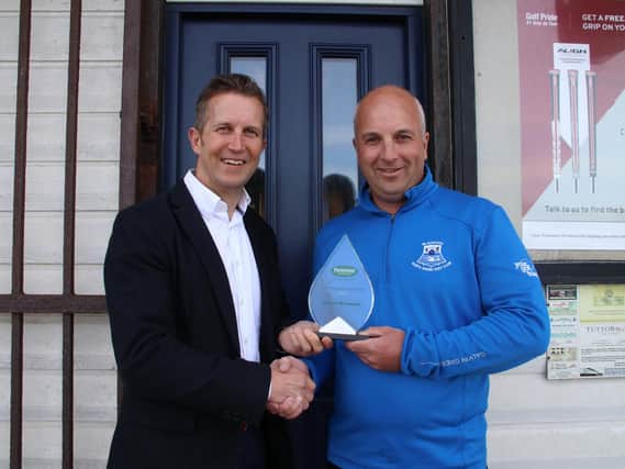Andrew Richardson of Blackpool North Shore (right) receives his award from Foremost managing director Andy Martin