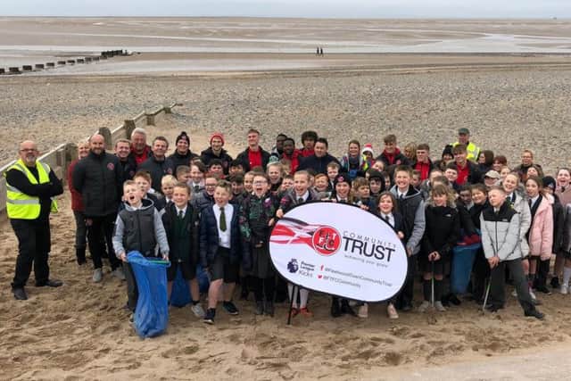 Towns U18s joined pupils from Shakespeare Primary School in litter picking on Fleetwood beach. Photo credit: FTFC