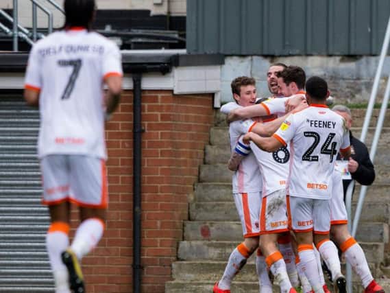 Matty Virtue is mobbed by his teammates after scoring Blackpool's second goal against Bradford City