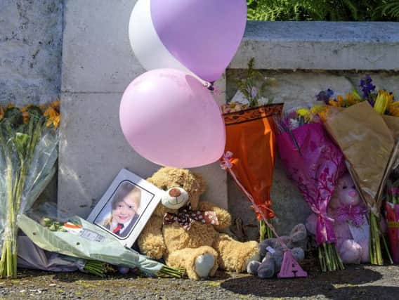 Tributes near a house on Ardbeg Road on the Isle of Bute in Scotland, after the body of Alesha MacPhail was found in woodland on the site of a former hotel by a member of the public.