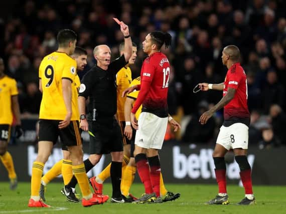 Manchester United's Ashley Young was Mike Dean's 100th victim