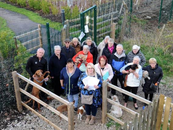 Residents gather to protest against the closure of the footpath