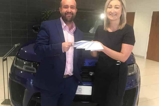 Jess receiving his prize from Rebecca Marsden, leasing sales manager.