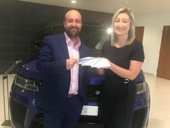Jess receiving his prize from Rebecca Marsden, leasing sales manager.
