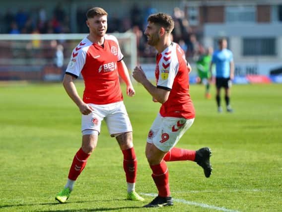 Ched Evans celebrates scoring against Southend with Wes Burns (left), who has extended his Fleetwood contract
