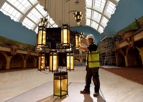 Chandeliers in the Spanish Hall at the Winter Gardens are given a final inspection before being hoisted up to the refurbished roof, which has been covered for over 10 years.  Pictured is Remy Dean.
