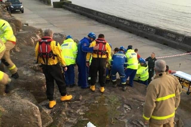 Rescuers formed a human chain to carry the man, 40, down the rocks after he plummeted onto them from the Promenade around 12 feet above
