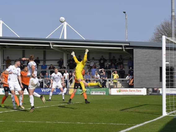 Nick Haughton's cross is punched clear by Barnet keeper Mark Cousins Picture: STEVE MCLELLAN