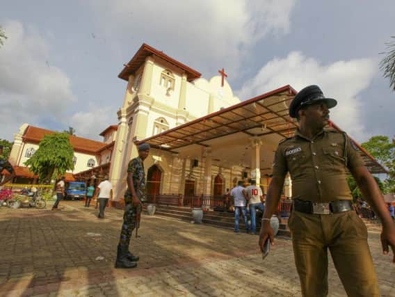 Sri Lankan army soldiers secure the area around St. Sebastian's Church damaged in blast in Negombo, north of Colombo, Sri Lanka, Sunday, April 21, 2019. More than hundred were killed and hundreds more hospitalized with injuries from eight blasts that rocked churches and hotels in and just outside of Sri Lanka's capital on Easter Sunday, officials said, the worst violence to hit the South Asian country since its civil war ended a decade ago. (AP Photo/Chamila Karunarathne)