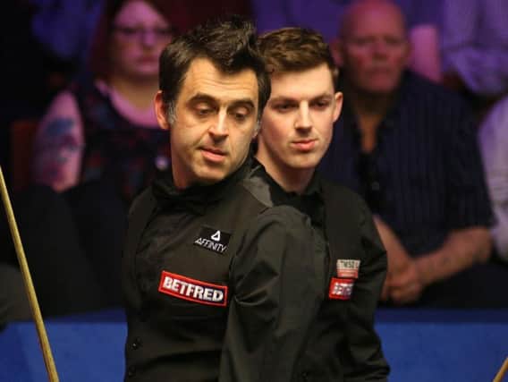 Ronnie O'Sullivan (left) and Blackpool's James Cahill head to head at the Crucible