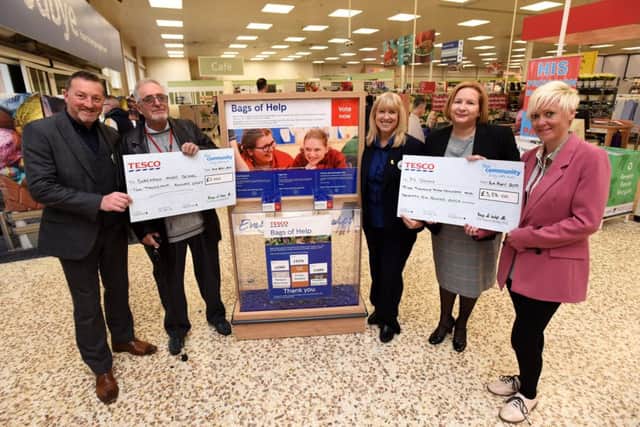 N-Vision and Blackpool Music School receive money thanks to Tesco's Bags of Help community grant scheme. L-R are store manager Simon Court, John Shaw from Blackpool Music School, community champion Lynn Sumner with Trina Parkinson and Maria Kirkland from N-Vision.