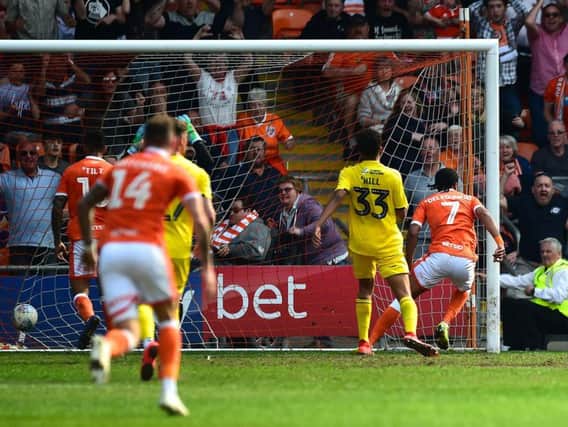 Nathan Delfouneso scores Blackpool's winner against Fleetwood despite the Bloomfield Road pitch