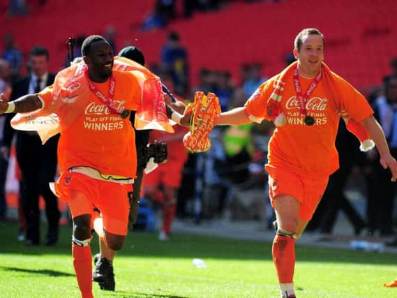 Jason Euell and captain Charlie Adam celebrate after the Championship Play off trophy the Coca Cola Championship Playoff Final between Blackpool and Cardiff City at Wembley Stadium