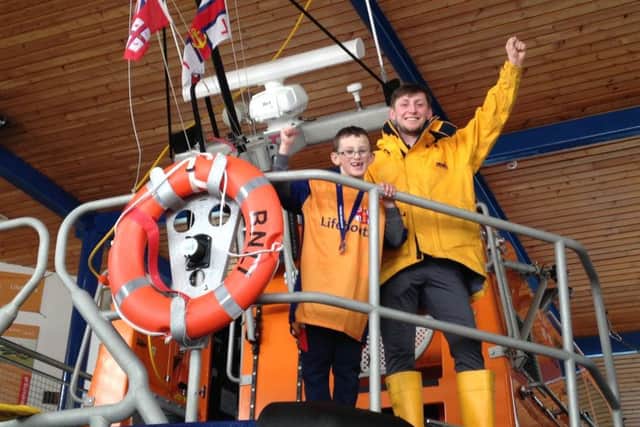 Six-year-old Dominic Stevens with RNLI crew member Josh Willder
