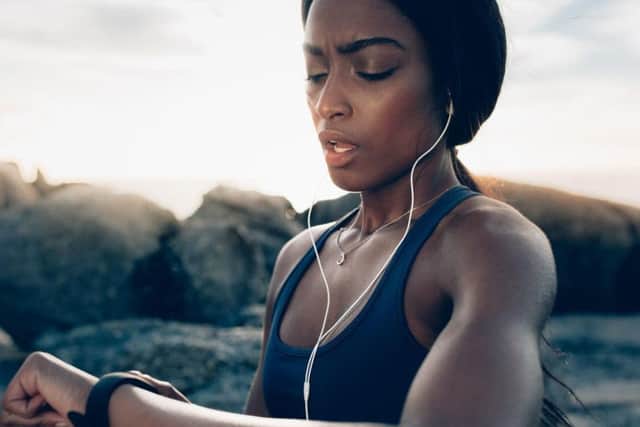 A woman looking at a wrist tracker.  Picture credit: iStock/PA.