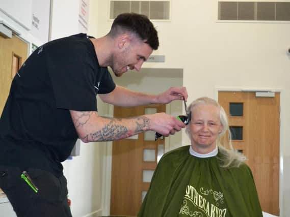 Ben Reynolds of Huntsman Barbers, Layton, shaves the head of Sister Louise McGuinness from Blackpool Victoria Hospital