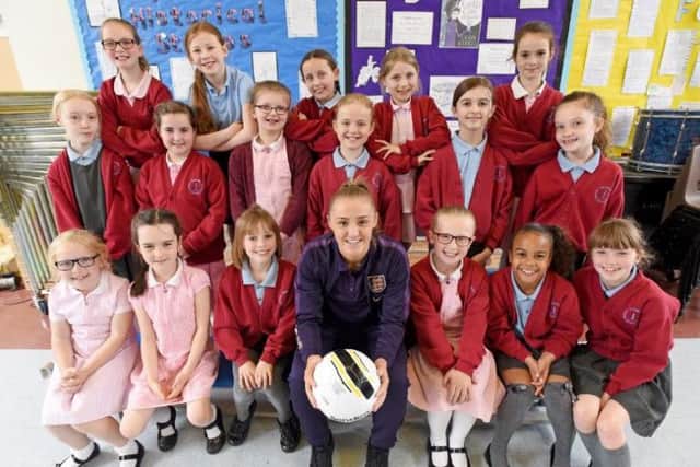 Man City and England footballer Georgia Stanway pays a visit to Baines Endowed Primary in Thornton.  She is pictured with youngsters from Key Stage 2.