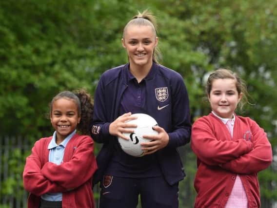 Man City and England footballer Georgia Stanway pays a visit to Baines Endowed Primary in Thornton.  She is pictured with pupils Serenna Hunte and Maisy Legge.
