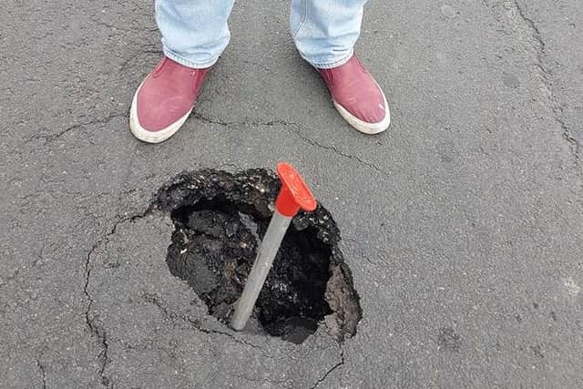 The pothole is at least 8 inches deep.