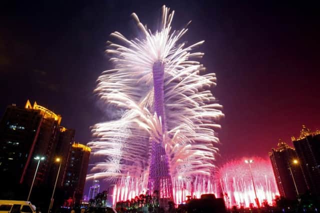 A firework display lights up the Canton tower during the opening ceremony of the 16th Asian Games in Guangzhou on November 12, 2010. Athletes from 45 countries and territories will compete in 42 sporting disciplines until November 27 as  the Asian Games officially opened with a glitzy gala ceremony, culminating years of planning for a massive event that is set to reinforce China's regional sporting dominance.  CHINA OUT   AFP PHOTO (Photo credit should read AFP/AFP/Getty Images)