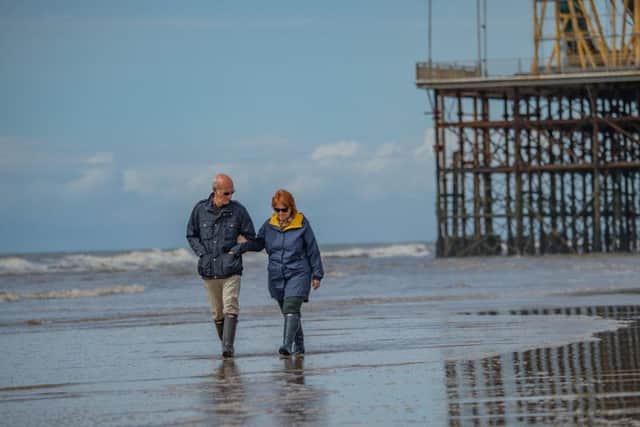 A couple take a stroll on the beach. A tiny drop in water quality saw it lose its Blue Flag status