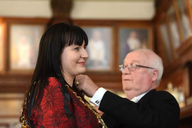 Coun Amy Cross is fitted with the mayoral chains
