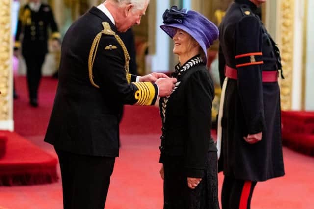 Dr Judith Poole receiving her MBE from Prince Charles