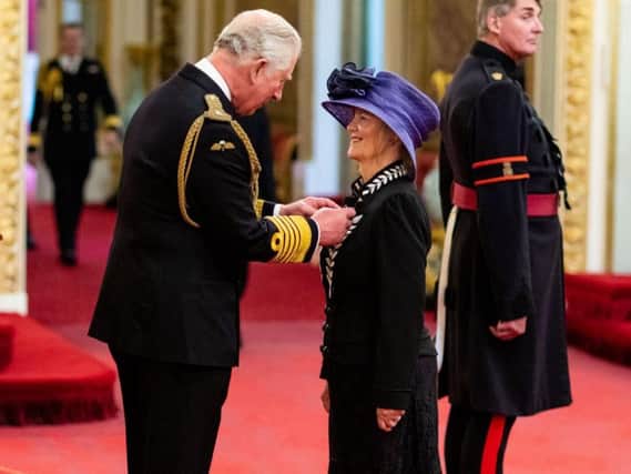 Dr Judith Poole receiving her MBE from Prince Charles