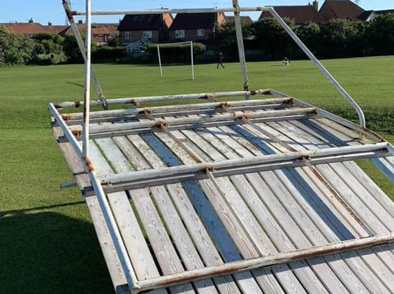 Wyre Cricket Club's sight screen lies wrecked after youths used it as a bike ramp.