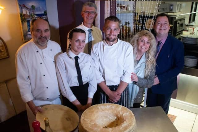 The San Marcos team with the cheese wheel