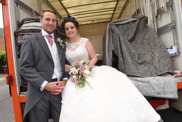 BLACKPOOL  31-05-19
The new Mr and Mrs Clark, Michael Clark and Stacey Morris, sat in one of the removal vans they arrived to church in. 

A couple who met through a removals business, arranged for removal vans from Clark and Son to take the bridal party to St Paul's Church, Marton, on their wedding day.