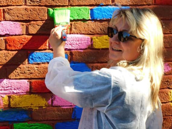 Jenny Sunley paints bricks at Blackpool Carers Centre