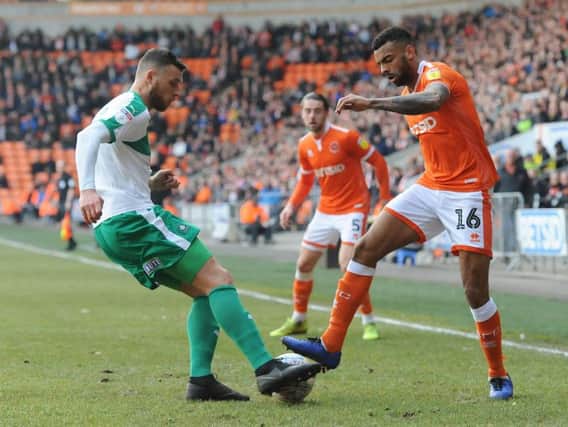 Edwards tackles Curtis Tilt during last season's encounter with Plymouth