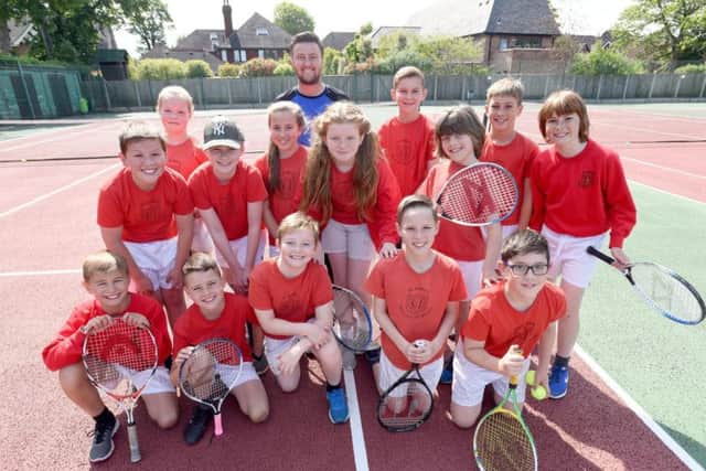 Head coach James Handforth with pupils from St John's Primary