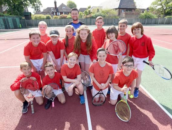 Head coach James Handforth with pupils from St John's Primary