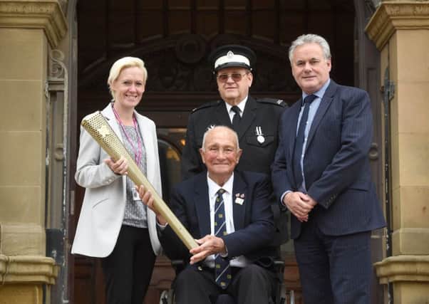 David Byrne is handing over the Olympic torch so it can be kept at Blackpool Town Hall.  He is pictured with coun Maria Kirkland, David Hoyle from St John's Ambulance and director of community and environmental services John Blackledge.