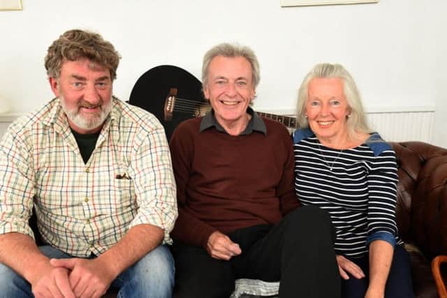 Alan Bowell is playing guitar again after losing part of his fingers after suffering septic shock.  He is pictured (centre) with friend Mark Russell and partner Alice Lomas