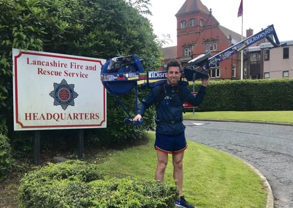 Former marine Matthew Disney walks through Preston carrying a rowing machine for an ex-armed forces charity