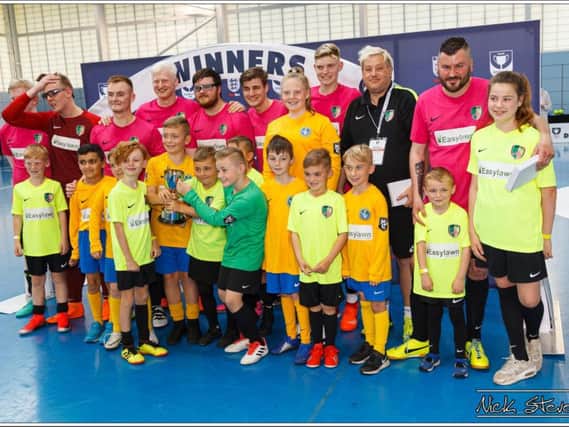 The North West Scorpions team who won the FA Disability Cup, with juniors from Spirit of Youth FC who helped as player escorts  Picture: NICK STEVENS