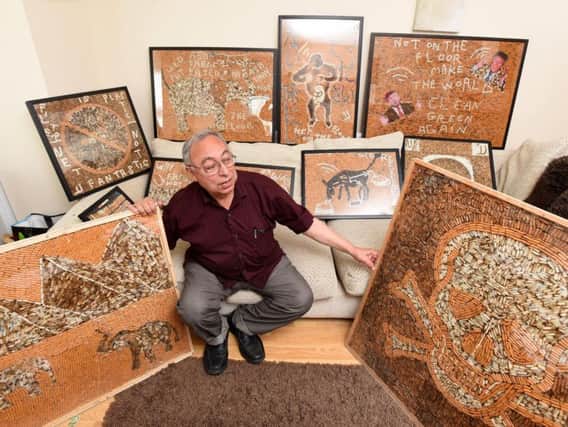 Negweny with some of the artwork he intends to display