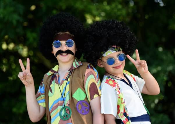 Pupils, parents and staff take part in BreckFest at Breck Primary School to celebrate 50 years, singing songs from 1968 and dressing in sixties clothes.  Jacob and Joseph Stock.