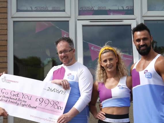 Paul Shanahan with Rosie and Adam  being presented with a cheque from the National Lottery