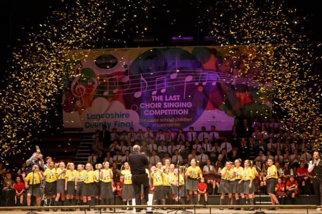 Golden ticker tape surrounds the winning choir Anchorsholme Academy