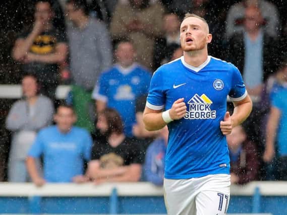 Peterborough United's Marcus Maddison is a wanted man