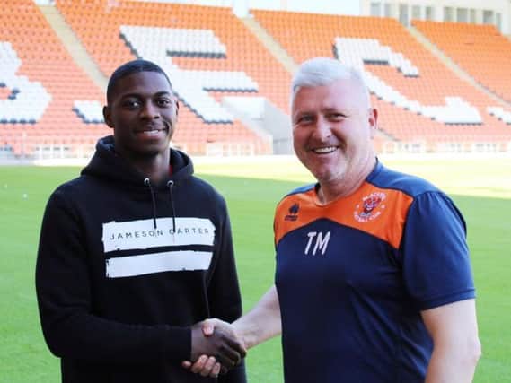 Terry McPhillips welcomes Sullay Kaikai to Bloomfield Road Picture: BLACKPOOL FC