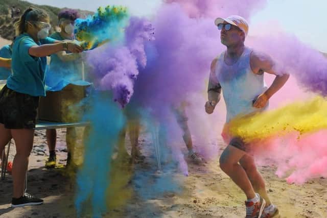 Trinity Hospice held its annual Colour Splash beach race on the sands at Starr Gate.
Crossing the rainbow finishing line.  PIC BY ROB LOCK
10-6-2018