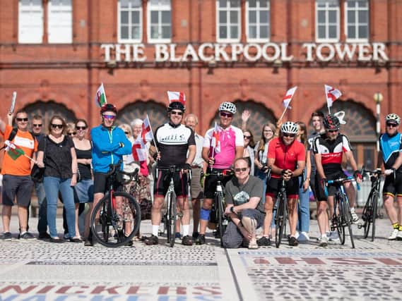 Michael and Richard Johnson and their fellow cyclists are welcomed to Blackpool by family and friends after their charity ride. Photo by Jill Reidy at Redsnapper Photography